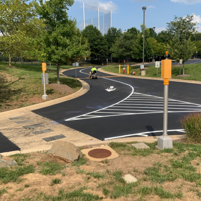 An empty parking lot with clearly marked white lines on the asphalt.
